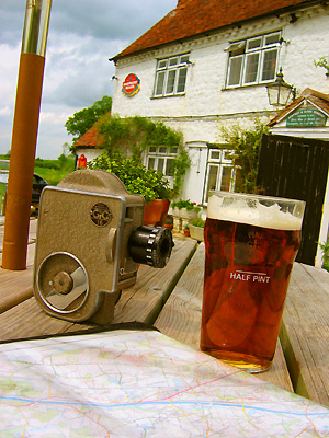 Pint, map, 16mm film camera, beer garden, Pepperbox pub, Fairbourne Heath, Ulcombe, Kent, England, Britain, UK