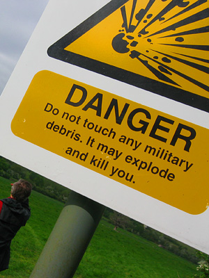 Danger: troops training sign in field near Abberton Manor, Colchester, Essex, England, United Kingdom